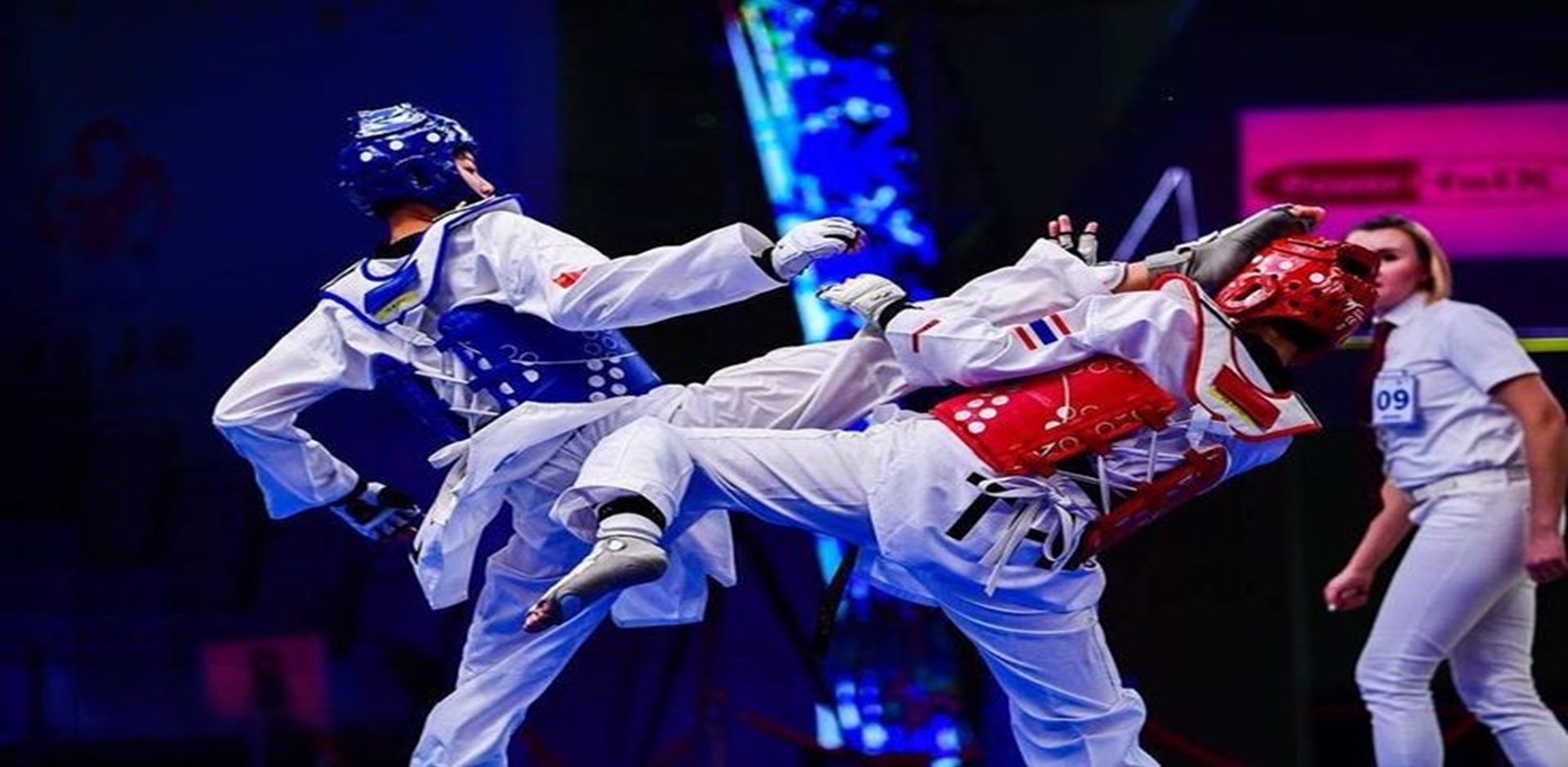 Two Taekwondo athletes competing